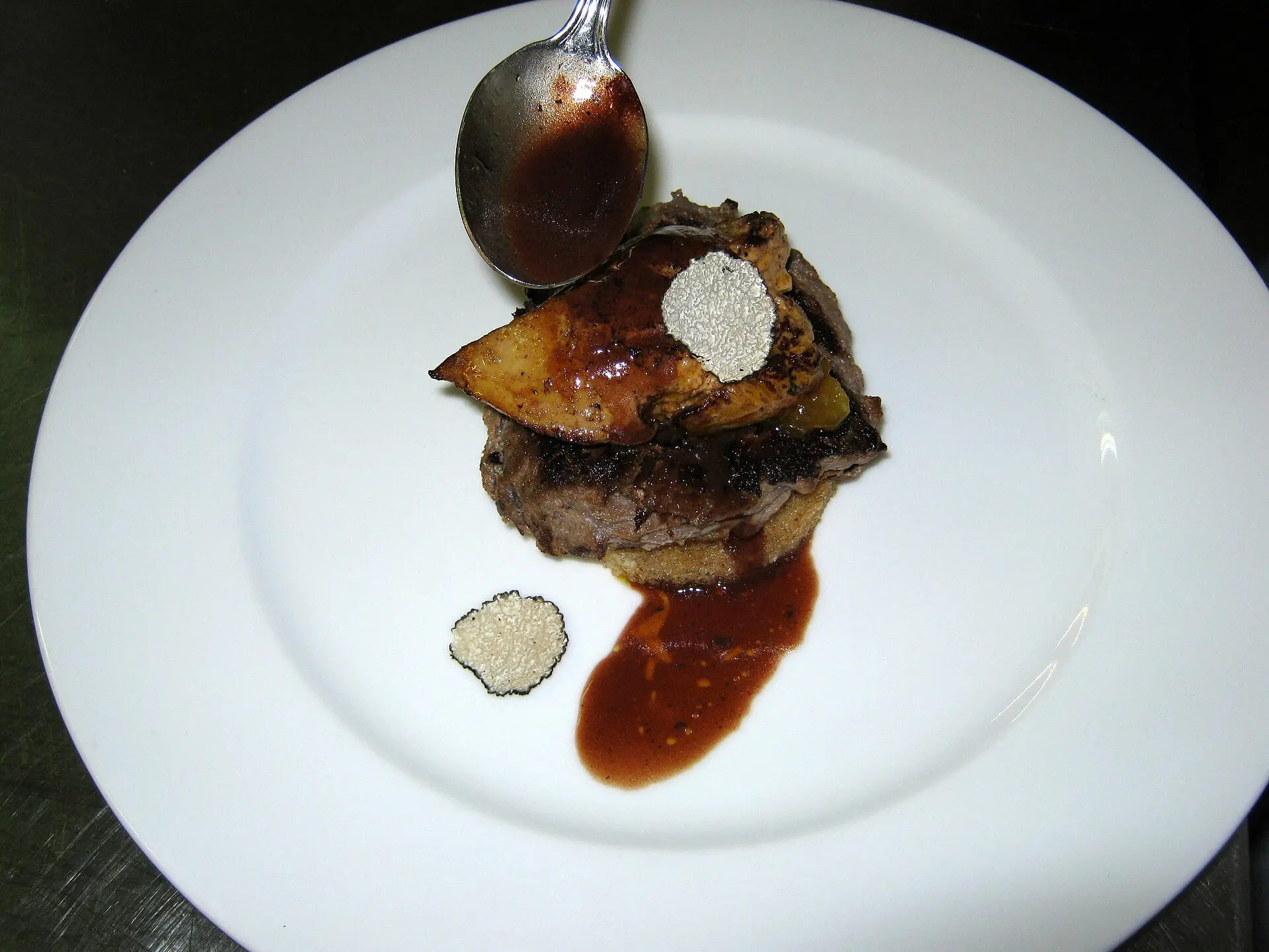 Tournedos Rossini: filet mignon with foie gras and black truffle on a crouton with Madeira sauce